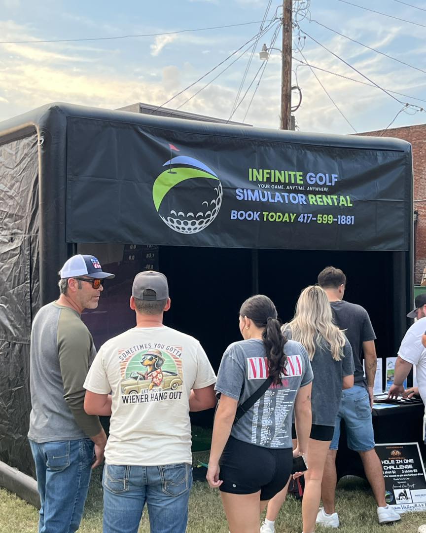 Guests gathered outside the Infinite Golf event booth