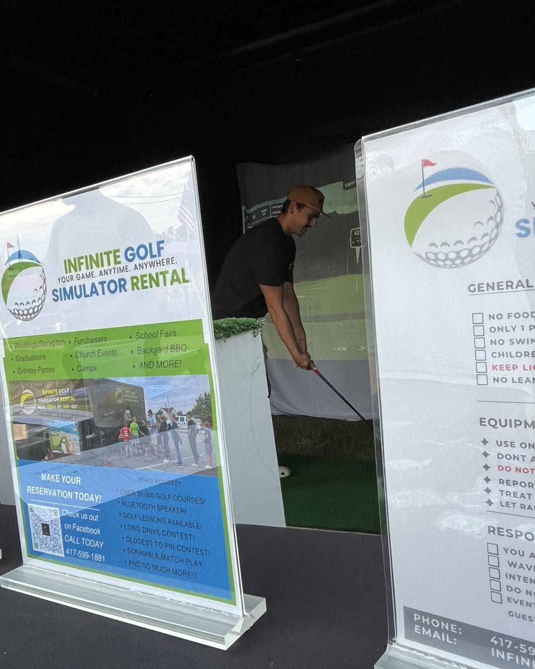 Fundraiser challenge signage and sponsor boards positioned beside the simulator station