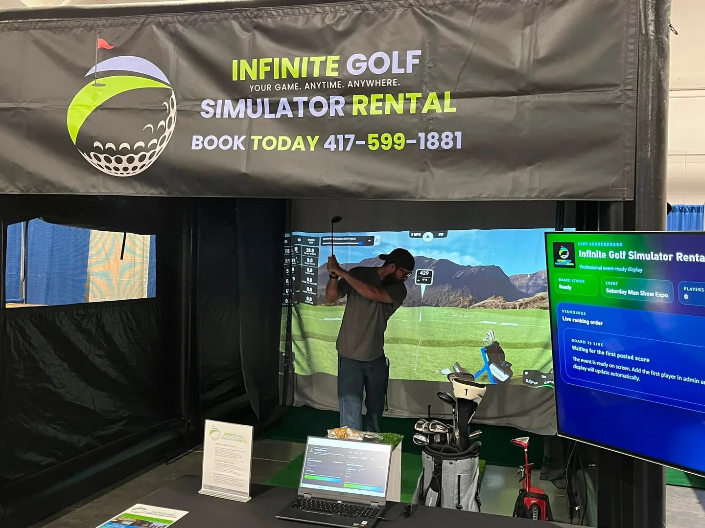 Actual Infinite Golf simulator screen, live event scoreboard, and operator station at the Ozark Empire Man Show Expo.
