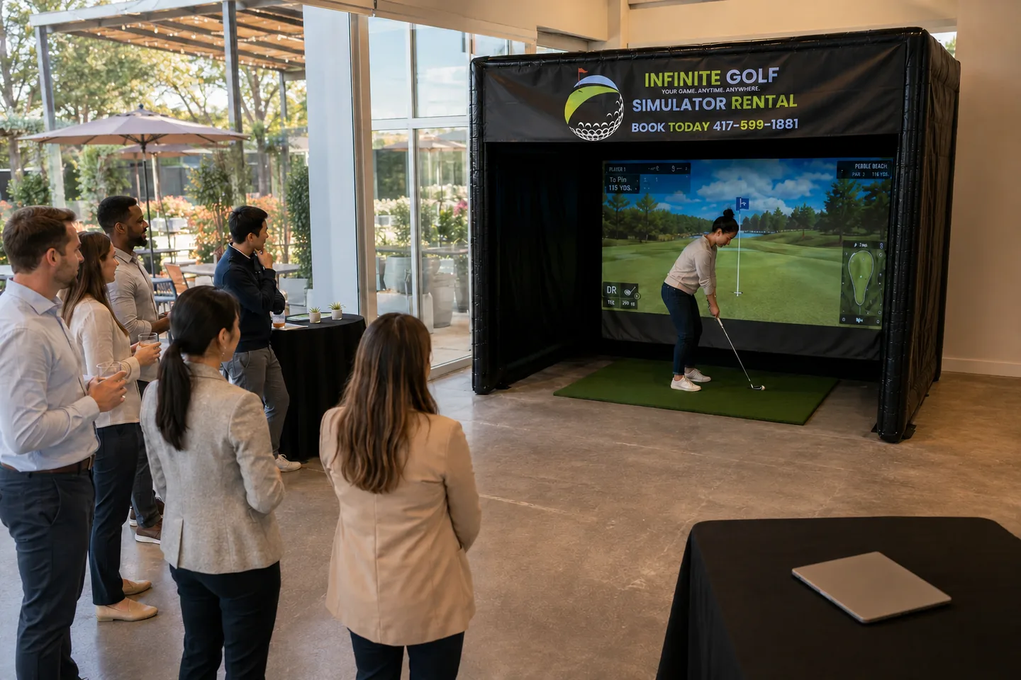 Representative inclusive team event with one golfer active and coworkers following from outside the Infinite Golf bay