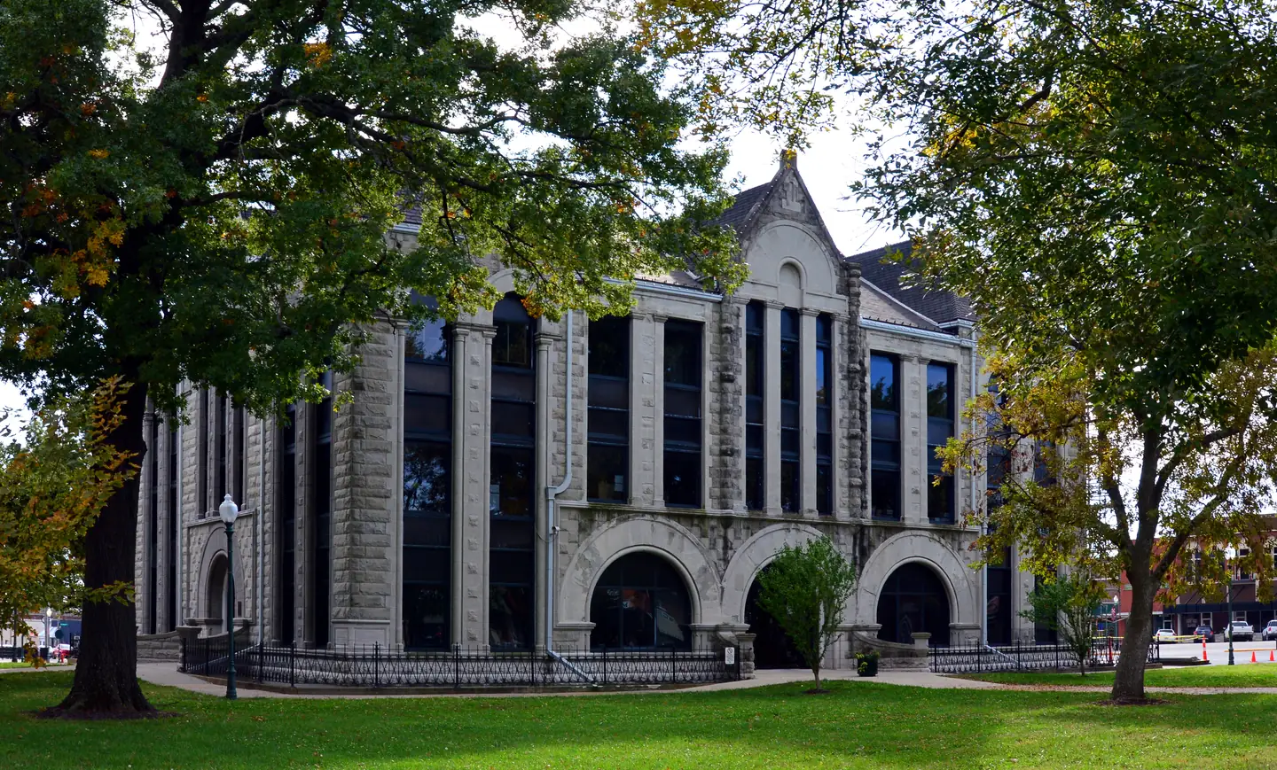 Henry County Courthouse framed by mature trees on Clinton's historic square in Missouri